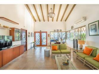 Mediterranean style living room with vaulted wood ceilings at Playa Blanca beachfront villa in Panama
