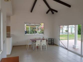Dining space with vaulted beam ceiling and garden view in Malibu Villas beach house Panama