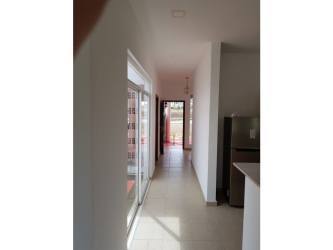 Private courtyard with white walls, sliding doors, AC units in beach house Malibu Villas Nueva Gorgona Panama