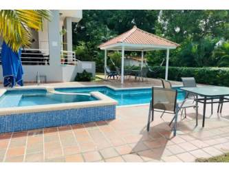 Swimming pool with hot tub gazebo and palm landscaping in PH Playa Blanca beachfront condo Rio Hato Panama