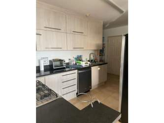 Modern kitchen with granite countertops, light wood cabinets, stainless steel appliances in PH Playa Blanca Rio Hato Panama