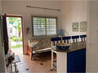 Cozy bedroom with blue headboard, coastal decor and tiled floors in PH Costa Grande Nueva Gorgona Panama