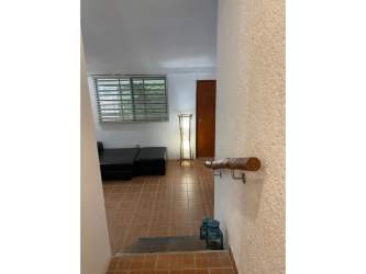 Exterior of single family house with stone driveway, lush gardens and palm trees in PH Costa Grande Gorgona Panama