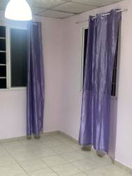 Street view with greenery, fence and trees at gated Veracruz complex Arraiján Panama rental apartment.