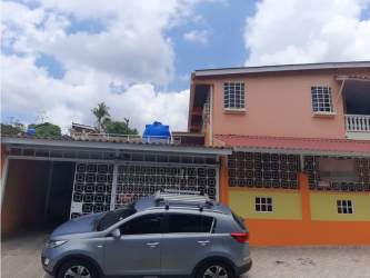 Covered parking garage entrance with security gates two-story house for sale Veracruz Panama