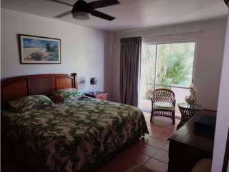 Master bedroom tropical decor private balcony ceiling fan wicker furniture at Costa Blanca Villa Panama