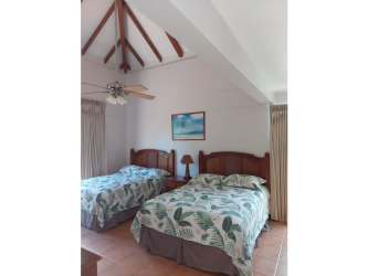 Bedroom with twin beds tropical decor vaulted ceiling in Costa Blanca Resort Villa Panama