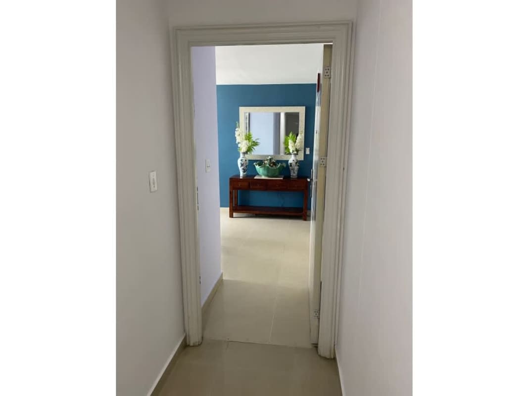 Furnished living and dining room with large windows and balcony in PH Green Point Panama City