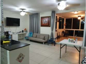 Spacious living and dining area with ceiling fan and balcony in PH Coral Park condo Playa Blanca Panama