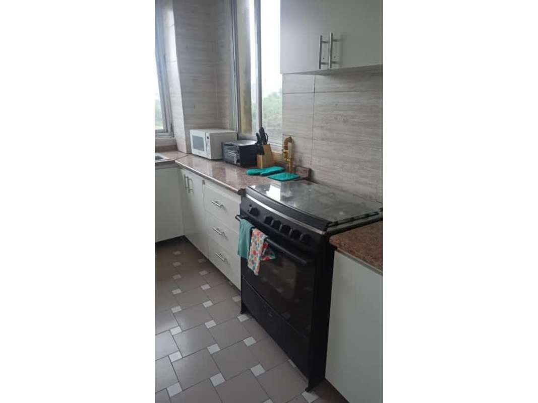 Swimming pool with red deck area, lounge chairs and umbrellas at PH Montecarlo in El Dorado