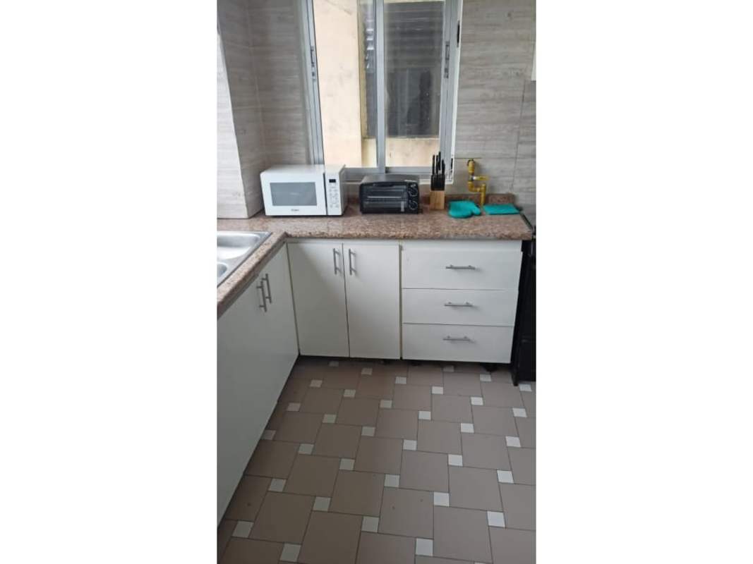 Contemporary kitchen with granite countertops, window view, microwave and stove in PH Montecarlo Panama