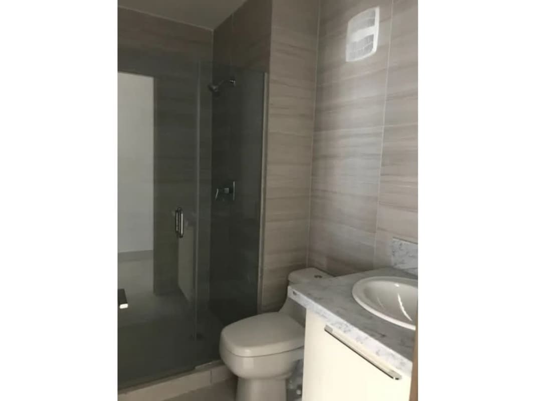 Bathroom with marble countertop, glass shower enclosure in PH Park City Obarrio Panama City