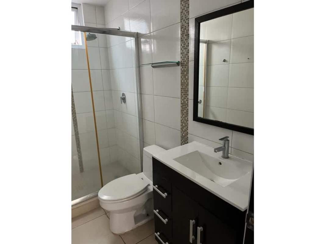 Large outdoor swimming pool with lounge chairs at Kings Park Panama City