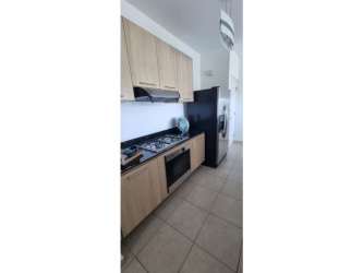 Kitchen with granite countertops, gas stove, black refrigerator in Bijao Beach Club Condos Panama