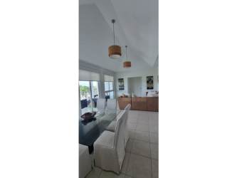 Spacious living room with vaulted ceiling, sectional sofa and terrace access in Bijao Residences Panama