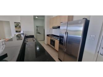 Modern kitchen with granite counters, stainless appliances in beach condo Panama