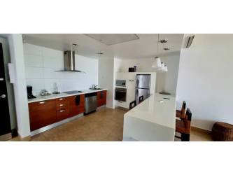 Bedroom with large window offering pool and ocean views in PH Nikki Playa Blanca