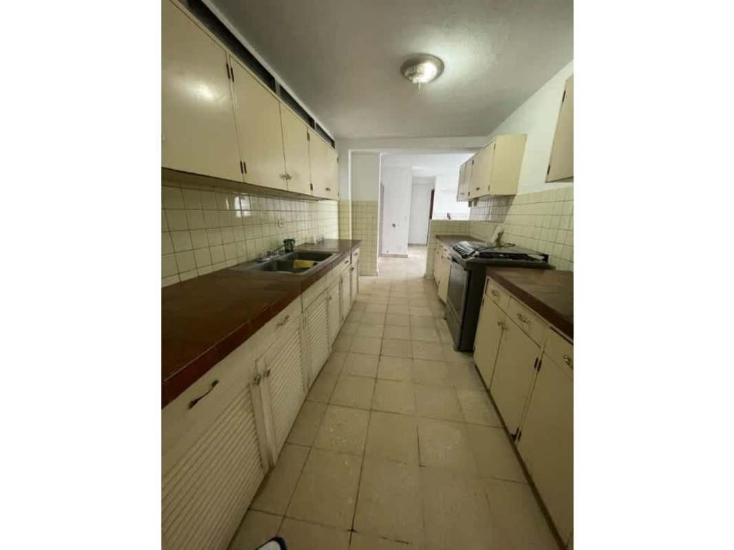 Covered balcony overlooking Panama City skyline with tile floor and railing in Pueblo Nuevo apartment