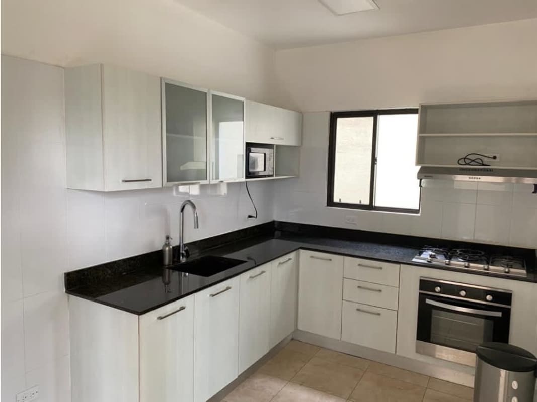 Bathroom with glass shower, granite counter, beige tile in house Vistas del Lago Panama