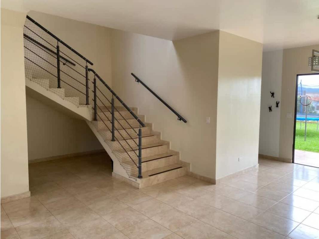 Living room with staircase, beige tile, open space in house PH Vistas del Lago Las Cumbres Panama