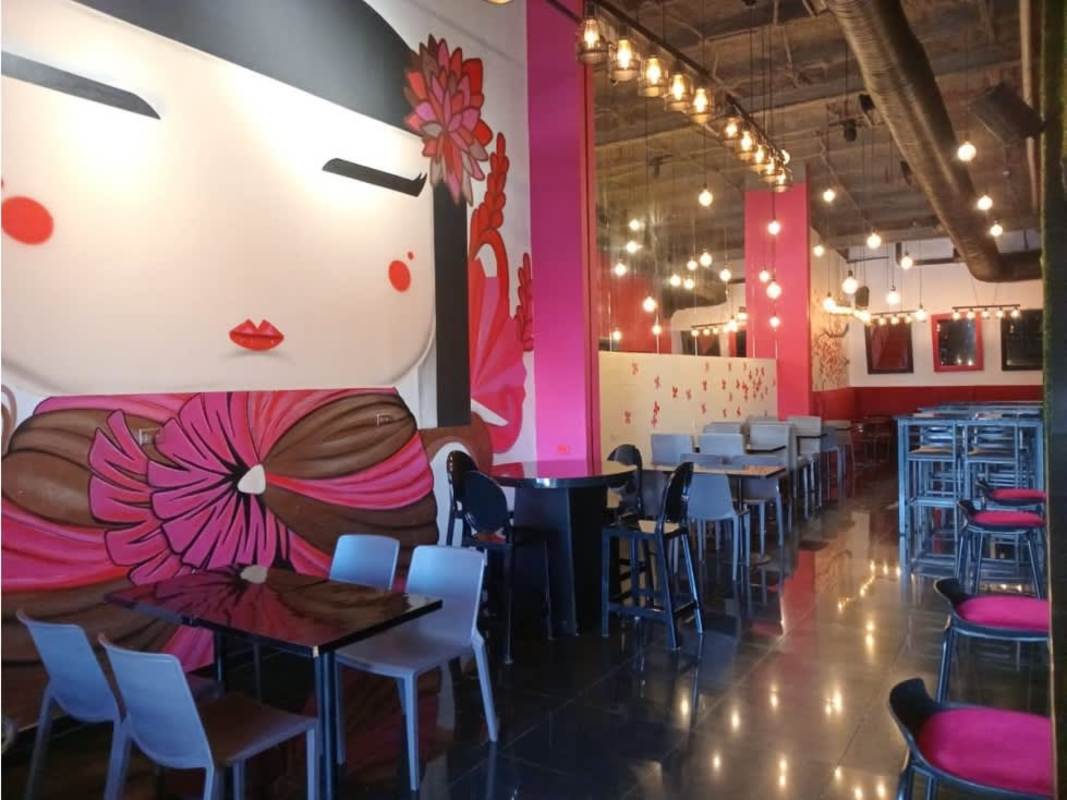 Industrial kitchen layout with stainless appliances and hood at Obarrio plaza