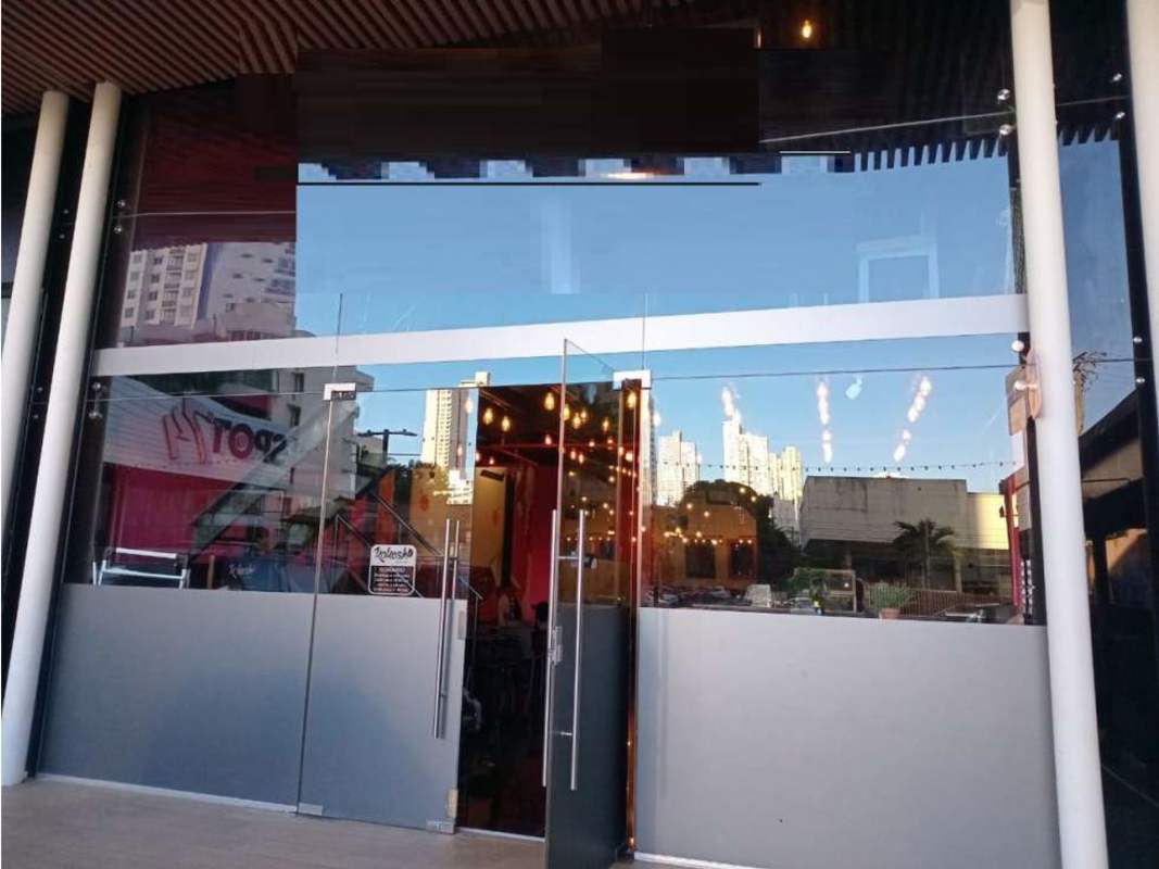 Colorful restaurant interior with wall art, pendant lighting, mixed seating for lease Obarrio