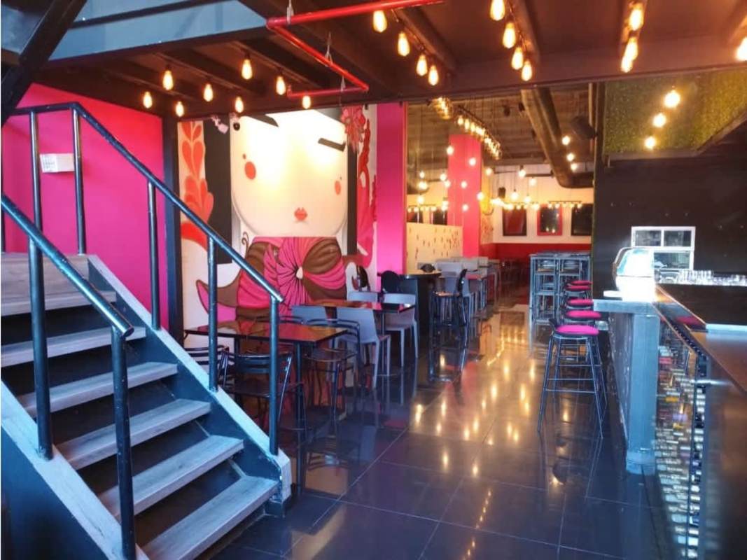 Modern bar counter with glassware and pendant lights in commercial rental Panama City