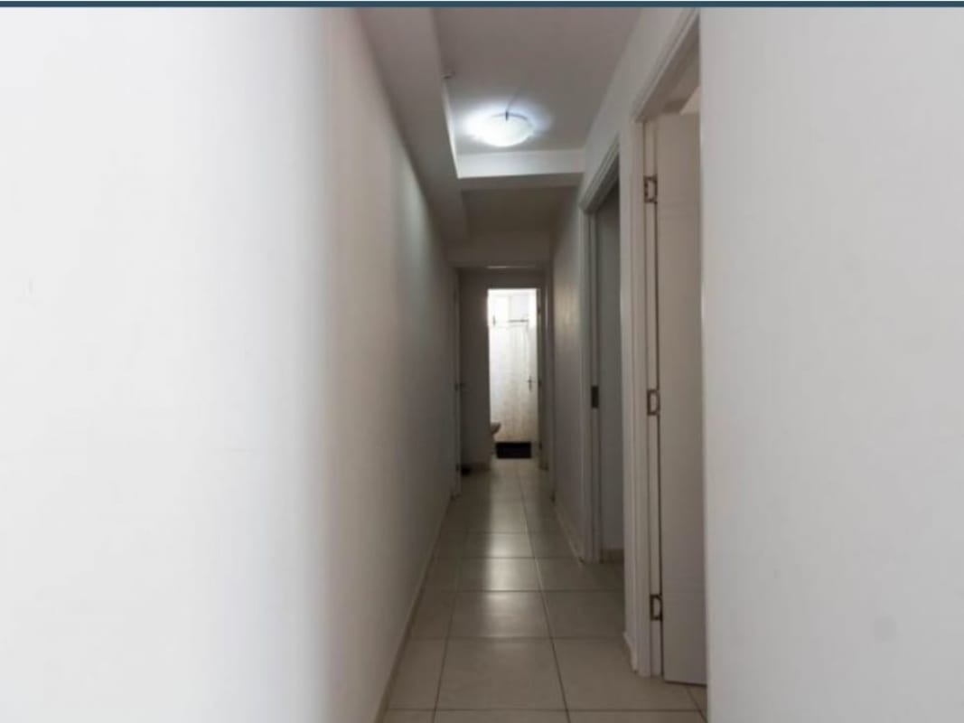 Long bright hallway with ceramic tile floors in modern apartment PH Mystic Valley Panama