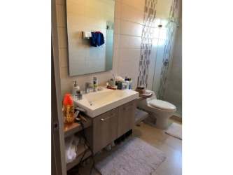 Modern open living room and dining with AC, large glass doors to patio in Bijao Resort Panama