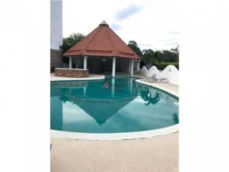 Swimming pool área with jacuzzi and gardens Punta Barco Resort Panama community amenities