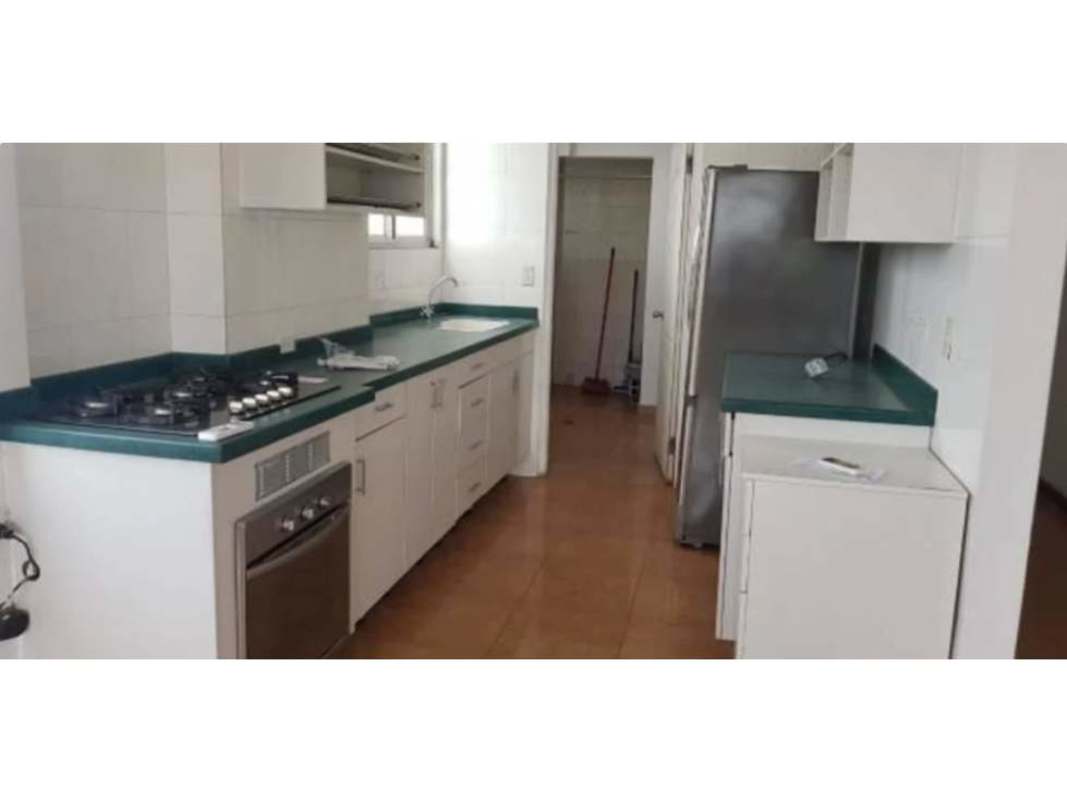 Apartment kitchen with green countertops, stove, fridge and storage cabinets in PH Fountain View Villa de las Fuentes Panama