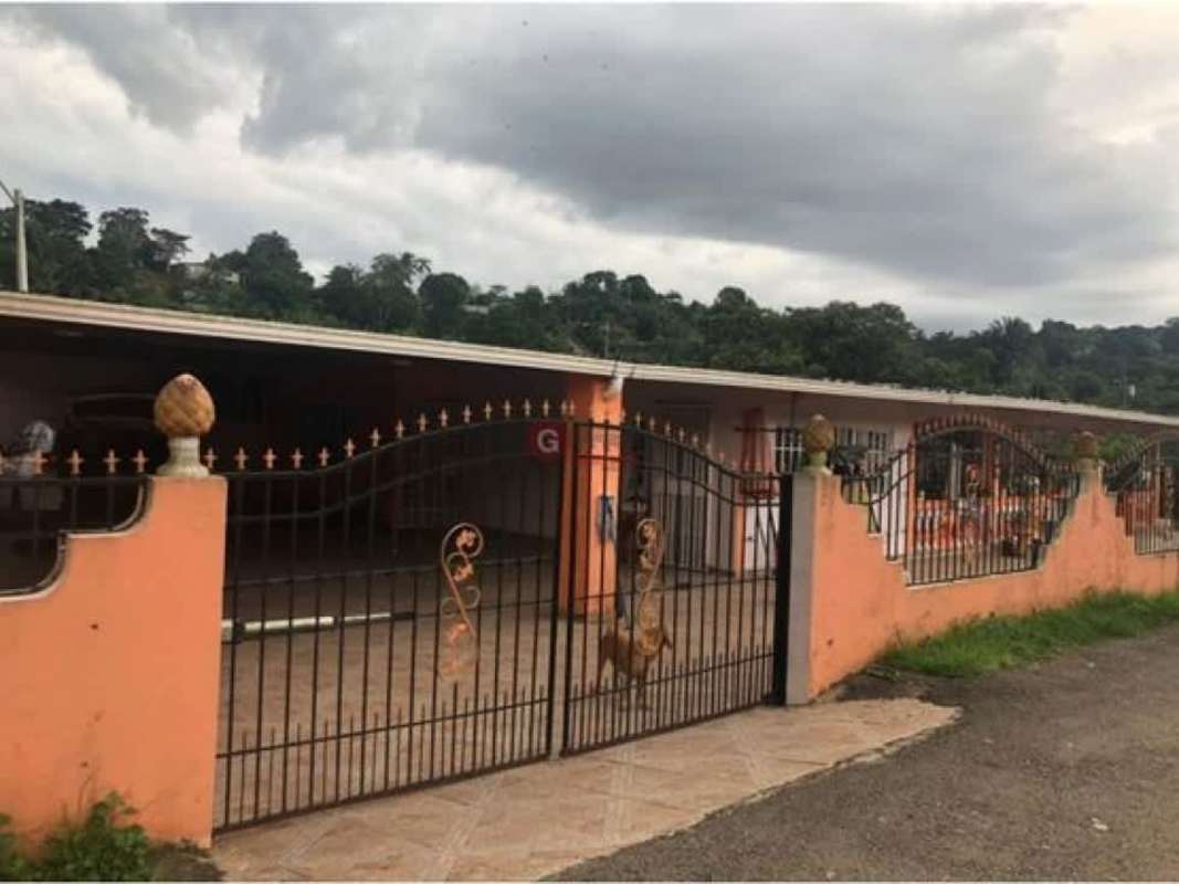 Single-story house with black metal fence and peach walls Villa Nueva Las Cumbres Panama