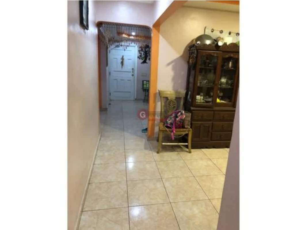 Hallway entrance with beaded curtain, arch, tiled floor in Villa Nueva Las Cumbres house