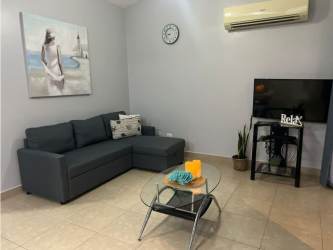 Modern kitchen with granite countertop, appliances, breakfast bar in Ibiza Beach Residences Panama