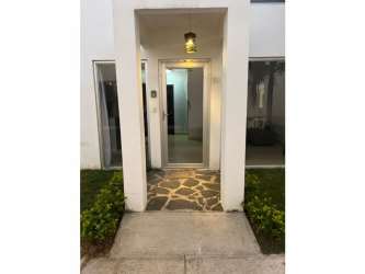 Living room with sofa, AC, and TV at beach villa for sale in Ibiza Residences Rio Hato Panama