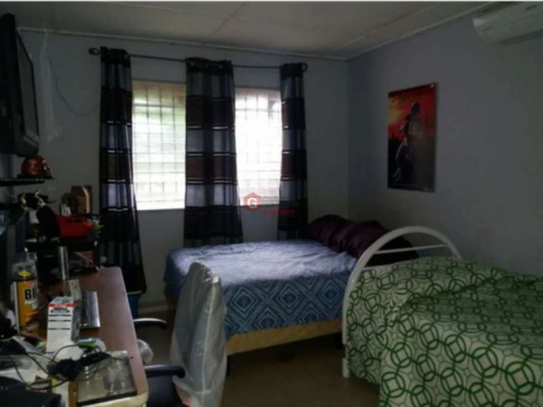 Living room with wooden ceiling, large windows and tiled floors house for sale Villa de las Fuentes Panama