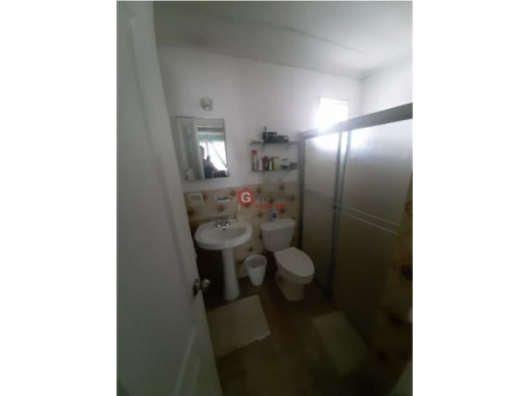 Traditional bathroom with bathtub, sliding glass shower door Panama house