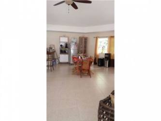 Rustic outdoor kitchen with tiled counters and bar at Punta Barco estate Pacific beach