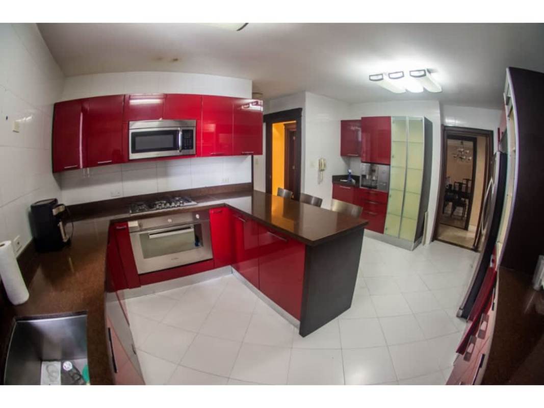 Kitchen with island seating red cabinetry PH Princesa del Mar Avenida Balboa Panama