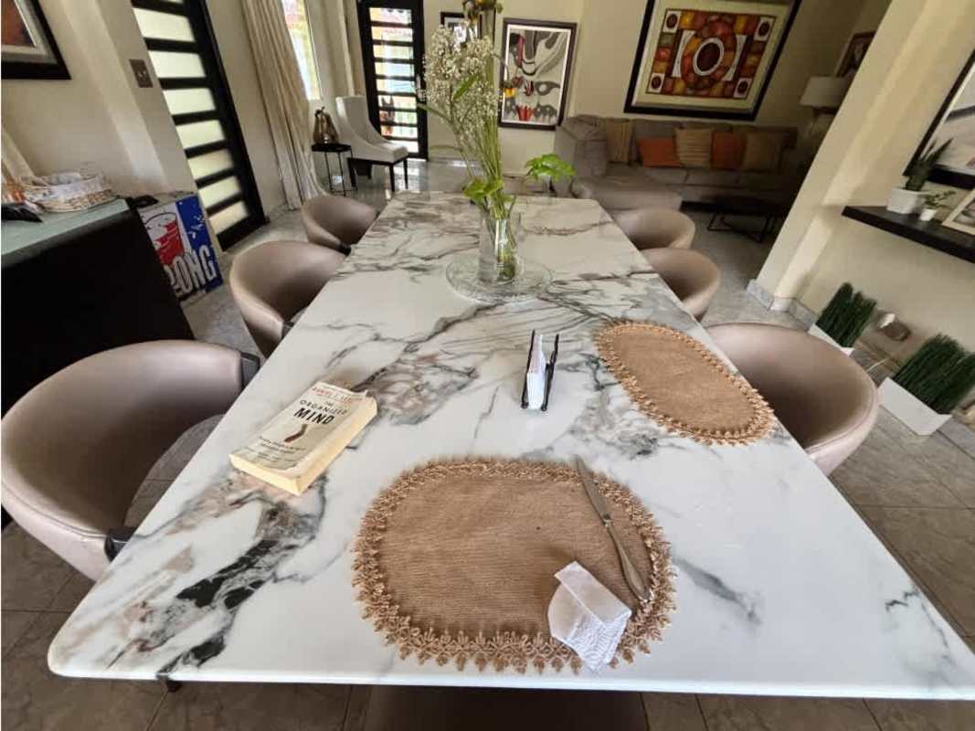 Equipped granite countertop kitchen with white cabinets and stainless steel appliances in Albrook home