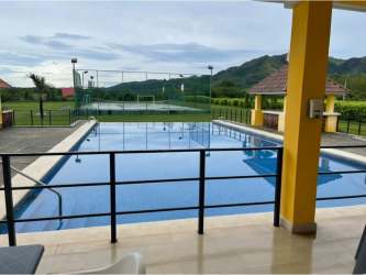 Outdoor swimming pool with tennis court nearby at PH La Colonia de Chame Panama