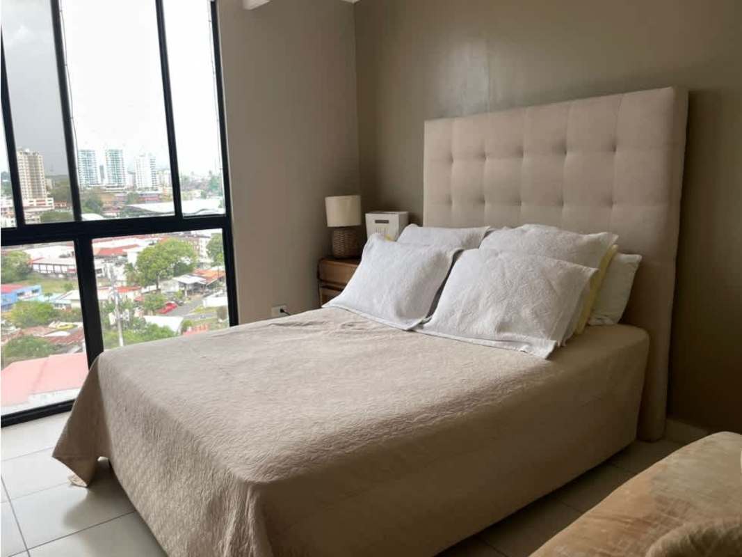 Master bedroom with city view, tufted headboard, natural light in PH Paradise Tower Hato Pintado Panama