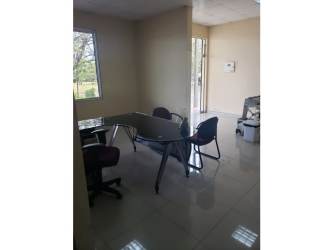 Contemporary office area with glass furniture and tiled flooring inside Santiago commercial property