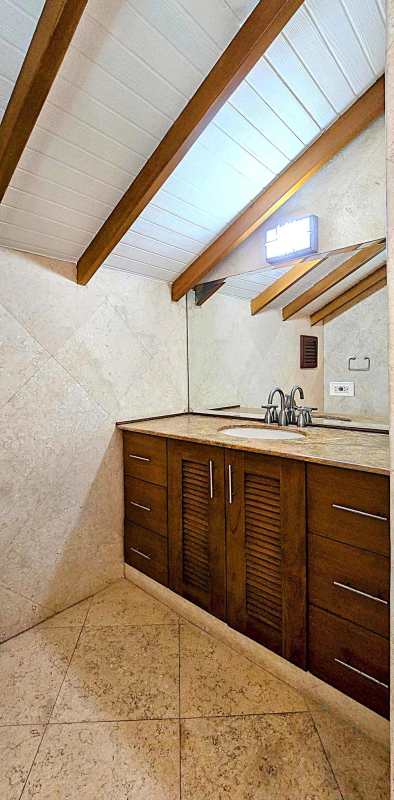 Spacious living dining area with stone wall and double height ceilings Casco Viejo penthouse