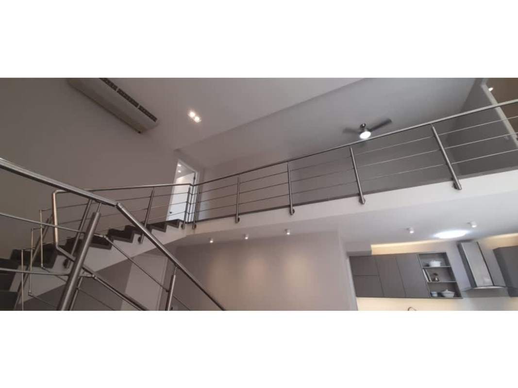 Modern kitchen with gray cabinetry stainless appliances PH Portanova near Via Argentina Metro