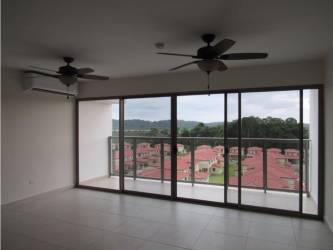 Spacious living room with sliding doors to balcony overlooking green areas Panama Pacifico