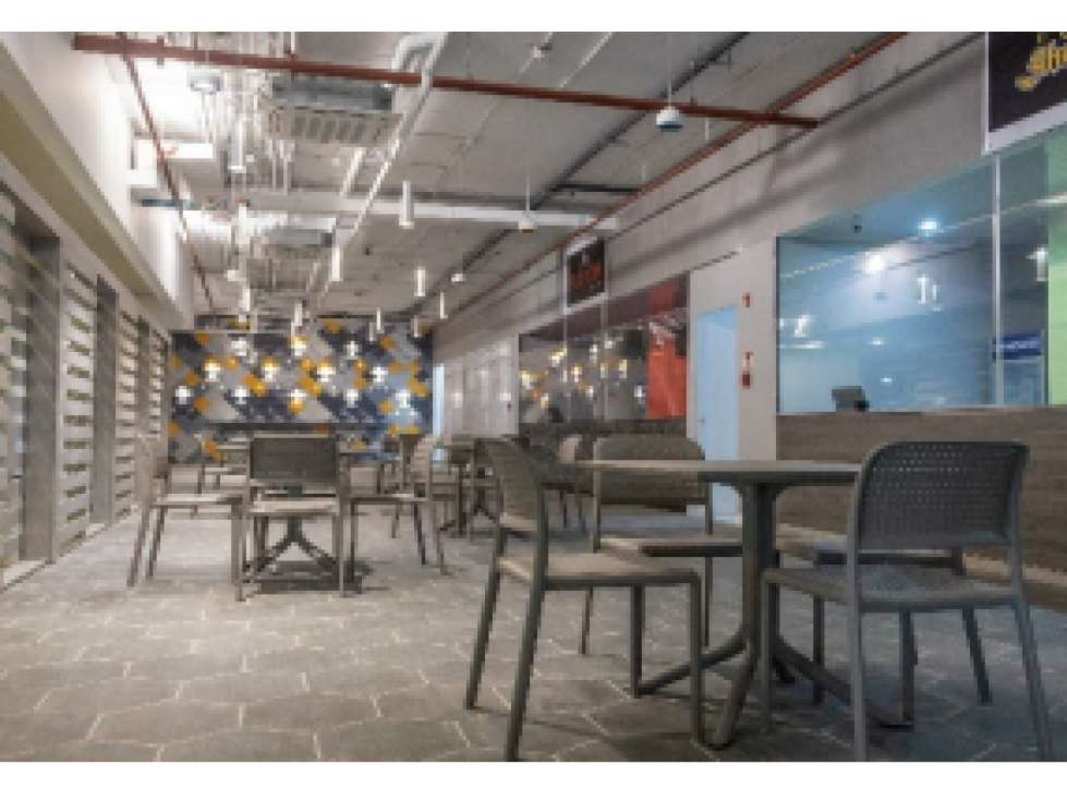 Modern commercial dining area with open seating and industrial decor in office tower