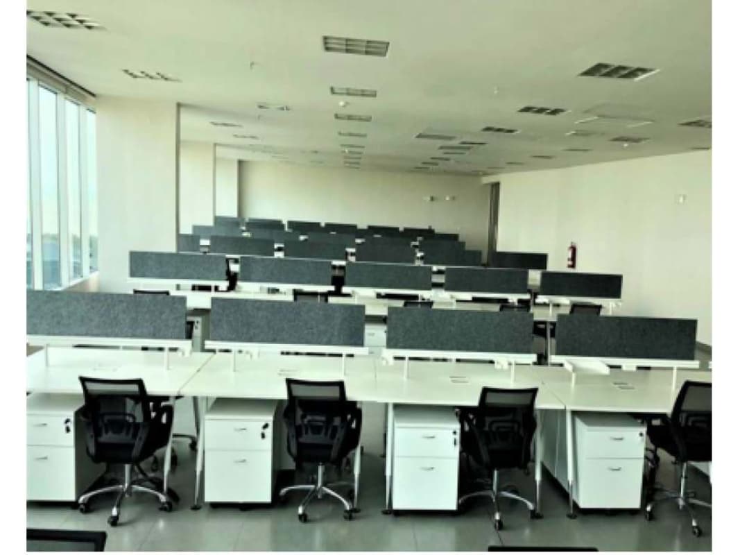 Spacious open workspace with desks, chairs, and city views Plaza del Este Costa del Este