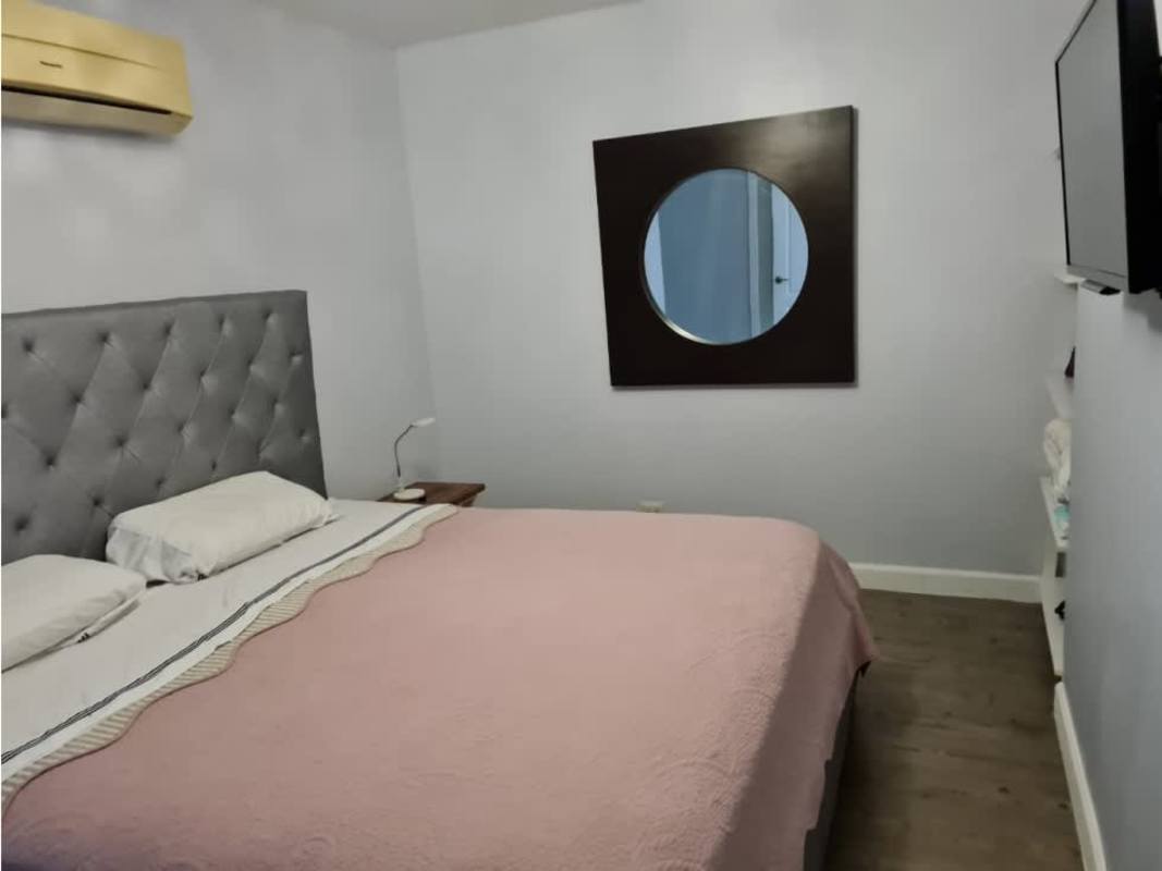 Contemporary kitchen with granite countertops, red cabinetry, gas stove at PH Pacific Sun Panama City