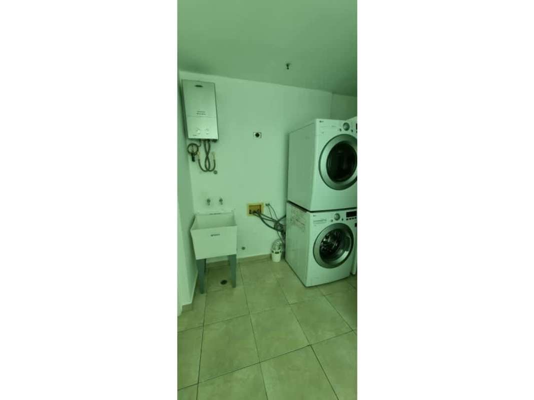 Laundry room with washer, dryer, utility sink in PH The Seawaves condo Bella Vista Panama.